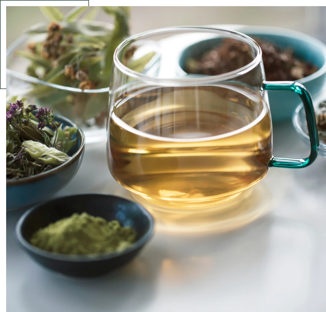 Glass of herbal tea with green powder.